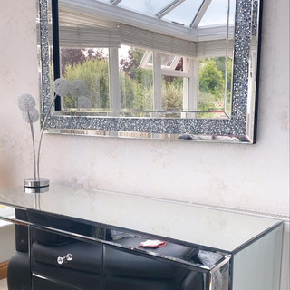 Mirror above chrome cabinet