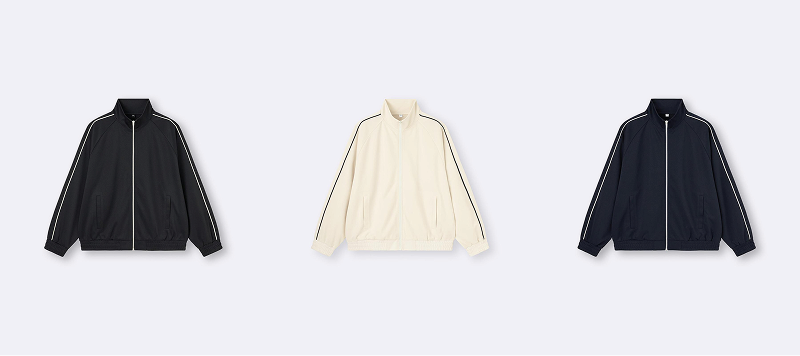 三個運動夾克並排放置,顏色為黑色、米色和深藍色。每件夾克都有白色條紋,背景為淺灰色