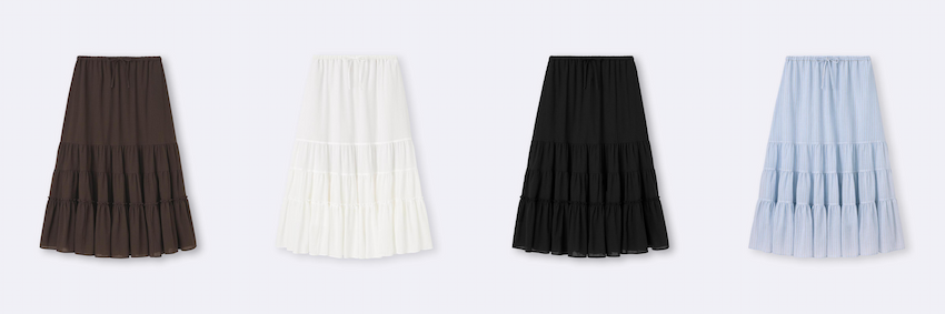 四條不同顏色的裙子並排在白色背景上,分別為棕色、白色、黑色和藍色,每條裙子都有層疊裙擺設計