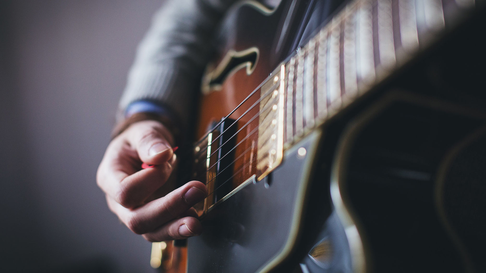 Musician playing a beautiful hollow body guitar.