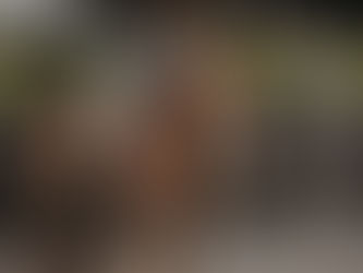 A rider on a horse at halt, giving her pony a hug.