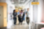 Design team walks down the hallway to their final presentation location