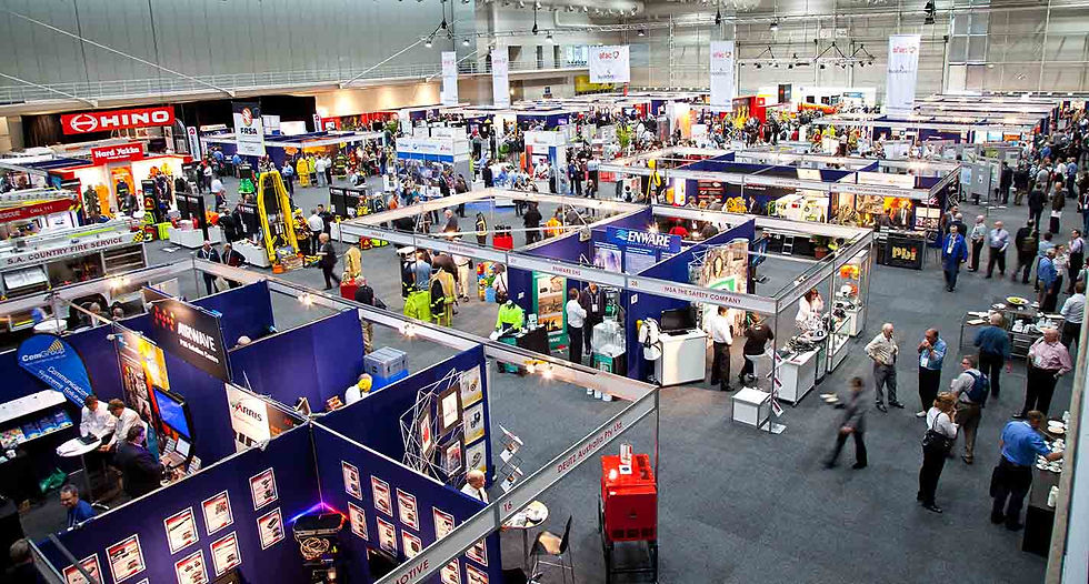 A busy trade show showing the various stalls and promotional items