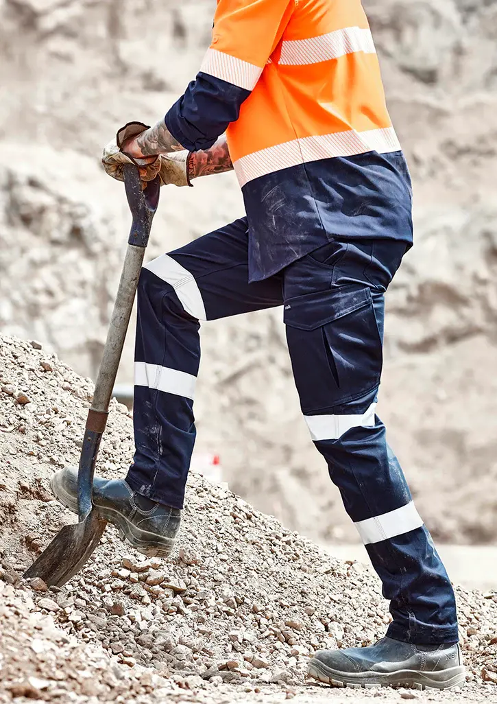 Worker wearing durable workwear in rough conditions showing resistance to wear and repeated use