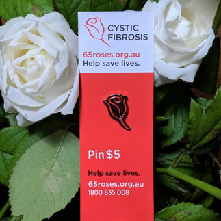 Cystic Fibrosis Queensland fundraising pin displayed on branded card with website and donation message, used for awareness and low-cost participation.