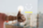 Finger pressing a glowing checkmark on a transparent screen with smiley face, five yellow stars, and cityscape background, suggesting satisfaction.
