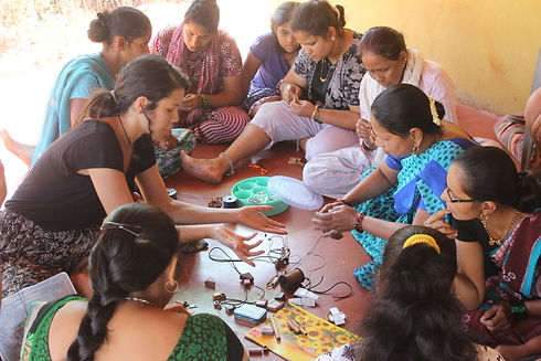 Project Tres founder Carla sits in a circle with the women from the project