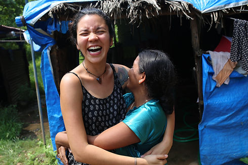 Project Três founder Carla and Farida hug and laugh
