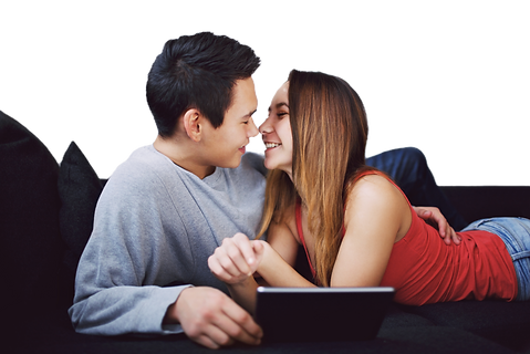 teenage-couple-on-couch-looking-at-each-