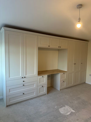 A large wooden wardrobe with shelving