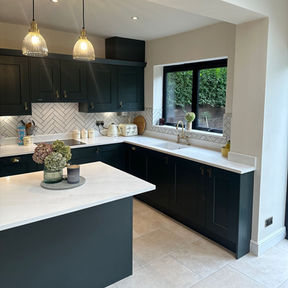 Modern kitchen with teal coloured cabinets and white metro tiles