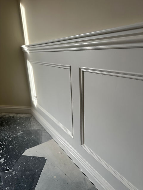 Wooden wall panelling that has been spray painted