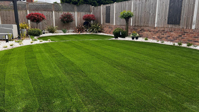 A garden with grass and paving