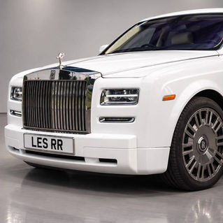 Front three quarter view of a white Rolls Royce wedding car displaying iconic chrome grille and LES RR number plate