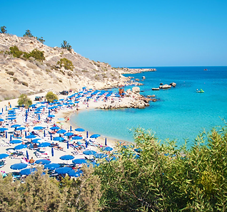 A beautiful beach in Cyprus with clear blue water.