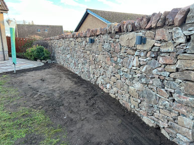 Expert stone masonry craftsmanship on garden feature wall