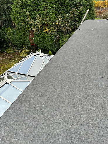 A flat roof overlooking a conservatory