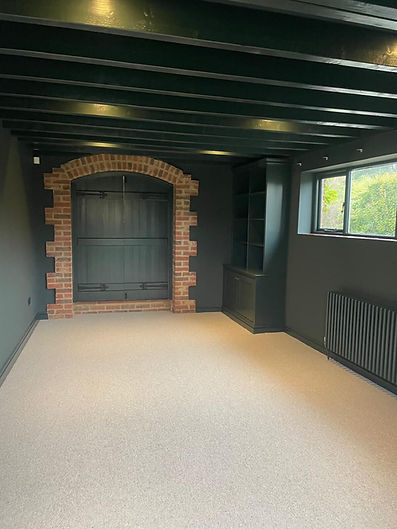 A room with green walls and a cream carpet