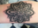 A black flower tattoo