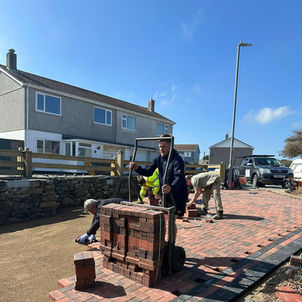 A brick driveway being paved