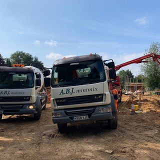 Two A B J Minimix lorries.