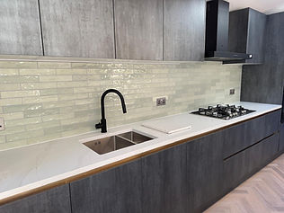 A modern kitchen with a tap and hob
