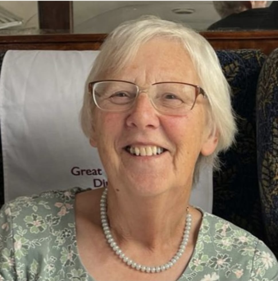 A photograph of a women with short cropped hair