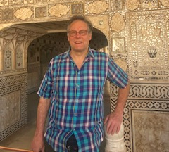 A Photograph of a man wearing a patterned T shirt
