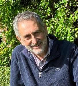 A Photograph of a man wearing a dark coloured fleece and patterned