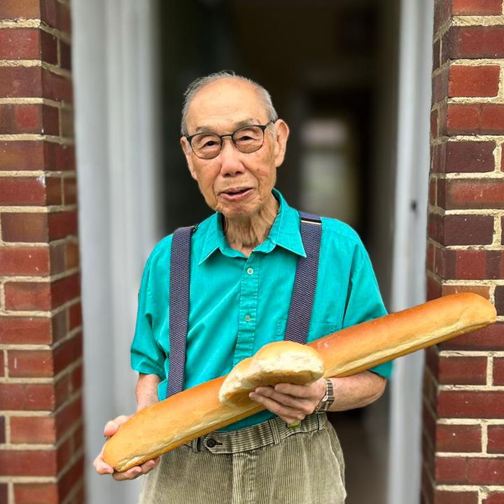 Resident holding loaves of bread