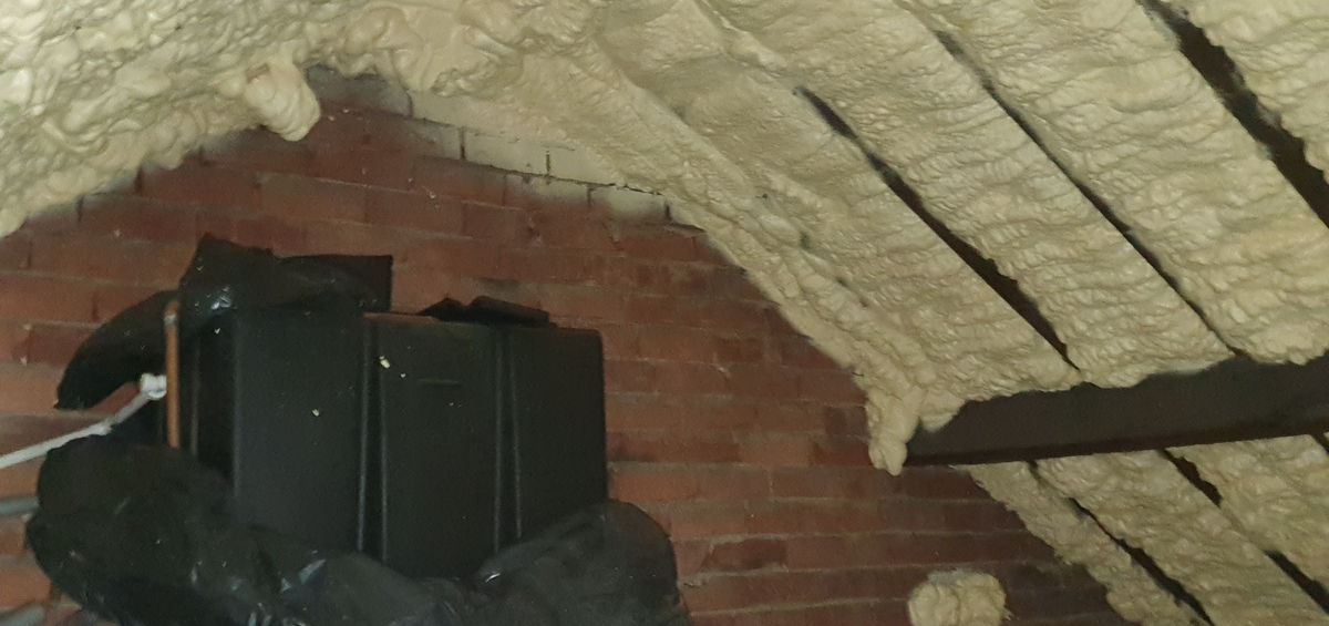 A photograph of spray foam loft insulation