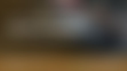 A professional Primeway Chauffeur driver assists a businesswoman with her luggage beside a luxury black Mercedes in London, showcasing reliable and premium UK taxi services.