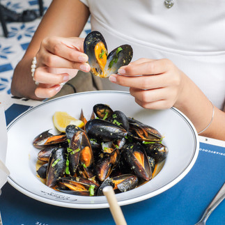 Someone holding a mussel open that looks like a heart shape