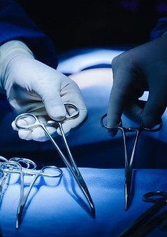 surgeons-hand-taking-scissors-forceps-surgical-instruments-table-room_33829-4.jpg