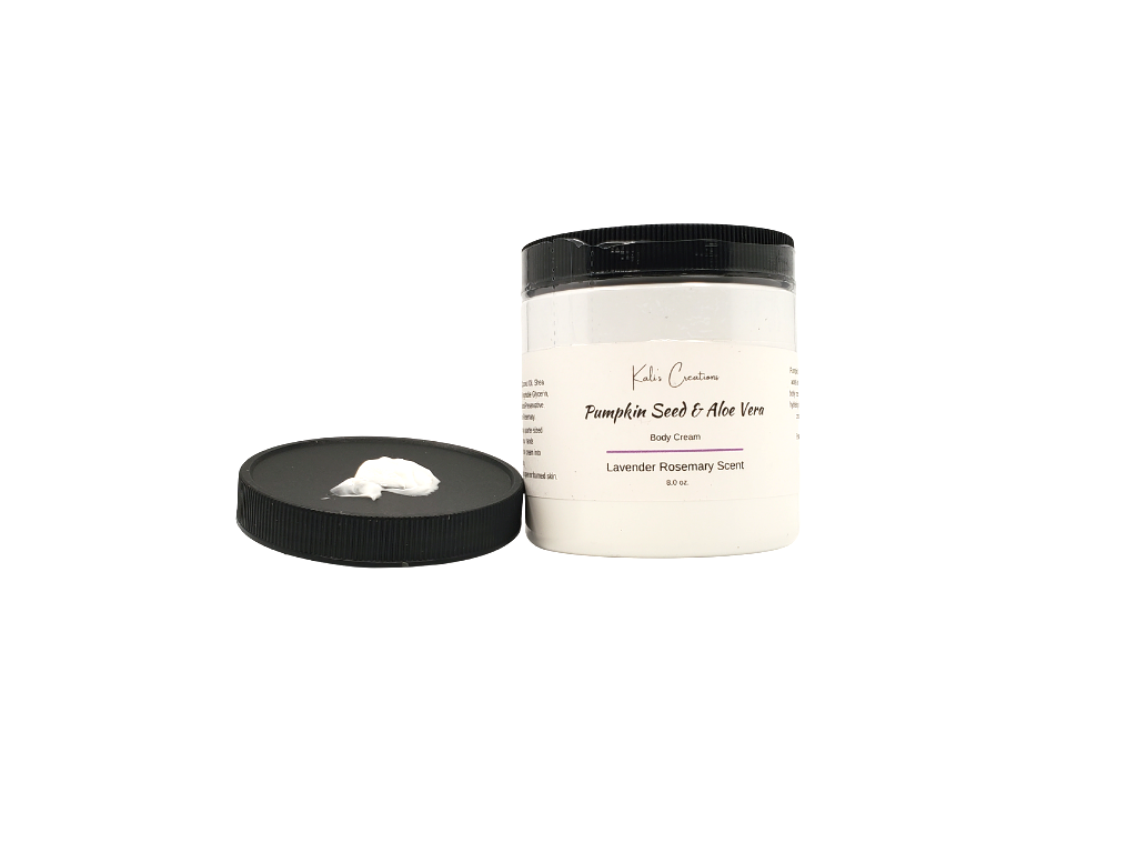 White jar with a black lid, featuring a small amount of lotion placed on top of the lid