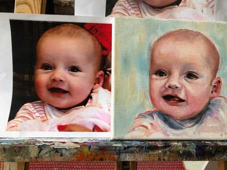 A photo of a baby next to a painting of the photo