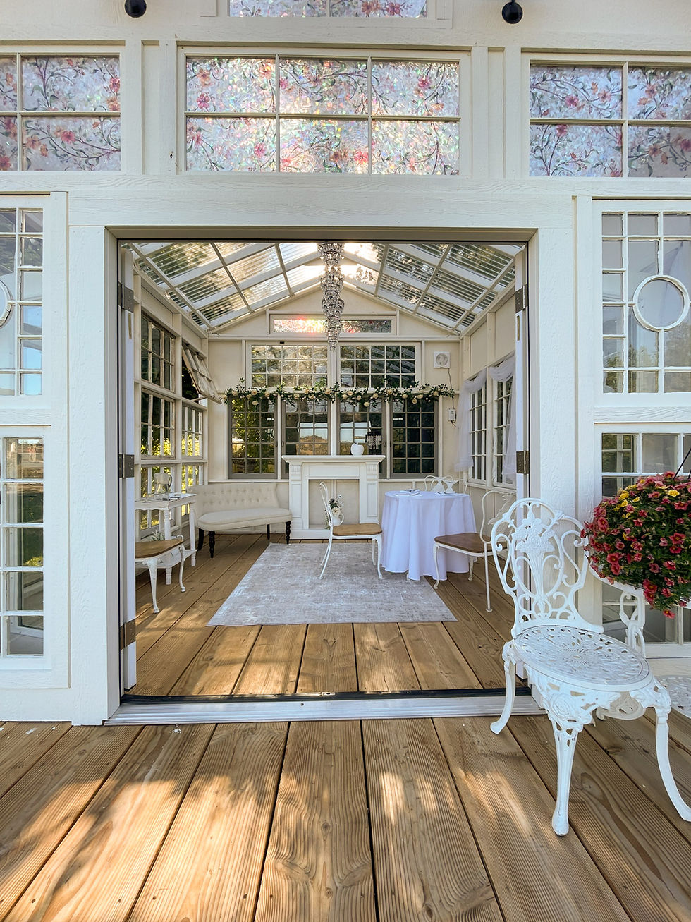 Looking into the Glasshouse set with a couch and a small table for three people.