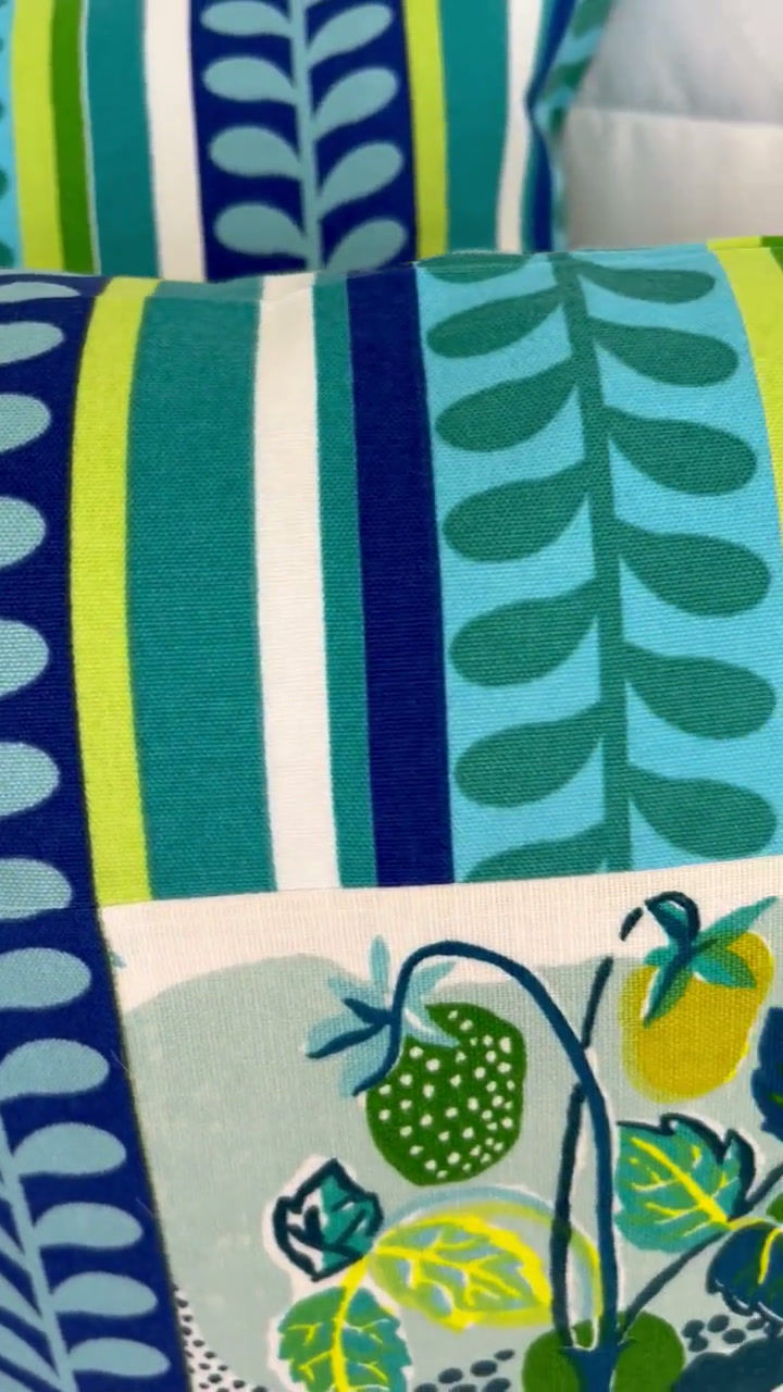 Thumbnail: The SCHUMACHER CITRUS GARDEN insert on an outdoor Fabric Pillow Cover features a vibrant teal blue, lime green, and white pat