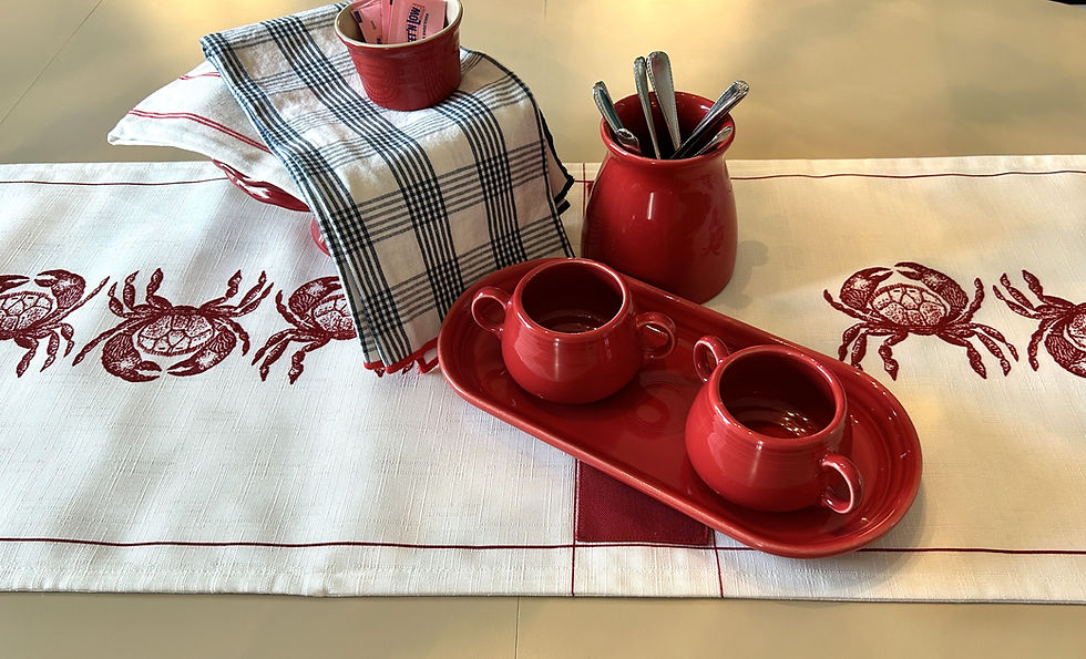 Thumbnail: This linen crab table runner is a custom seventy- four- inch reversible runner with a whimsical pattern of red crabs on a whi
