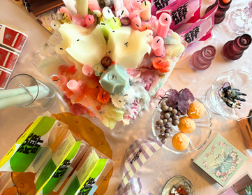 melting neon candles and sockerbit candy on table at fine art fruit shop in portland
