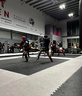 Kickboxing students training with instructors at Capicio dojo