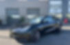 photo d'une tesla noire avec un film ppf brillant