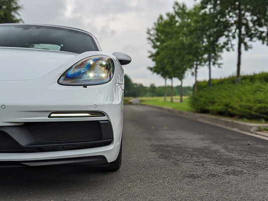 porsche blanche sur une route de campagne