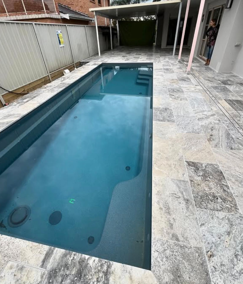 Modern concrete pool and outdoor entertaining area for a narrow backyard in Menai