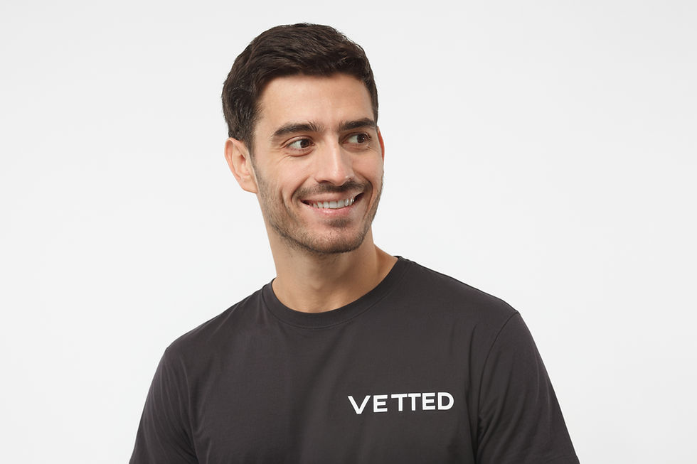 Smiling man wearing Vetted branded top, showcasing expert UK property auction legal pack reviews.