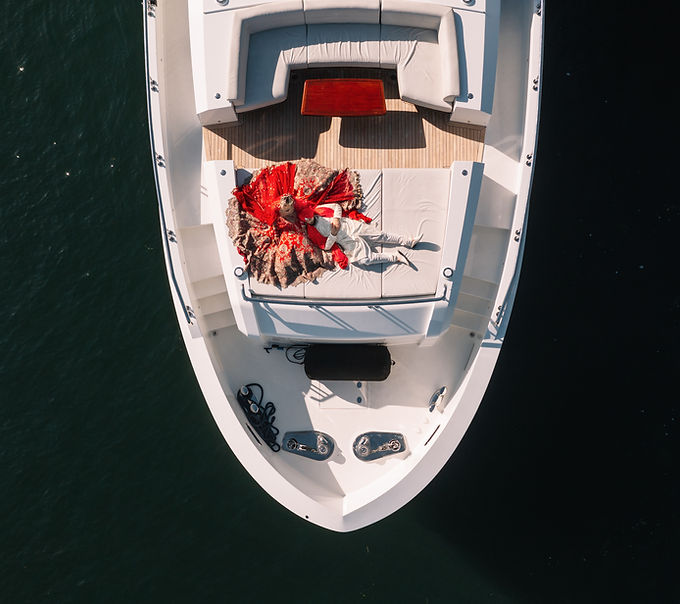 A bride and groom relaxing in the sun on the bow of the Voyager Superyacht in Seattle's Lake Washington