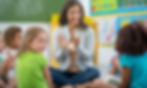 Early Childhood Educator clapping with kids in a classroom