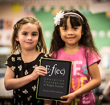 Two Eagle County, Colordo students holding an Education of Eagle County sign.