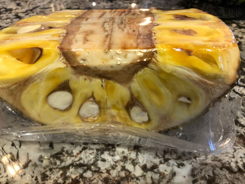 This is a jackfruit. Remove the seeds and white pith to eat the yellow flesh.