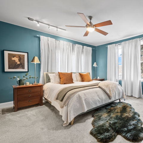 Spacious bedroom, teal walls, king bed